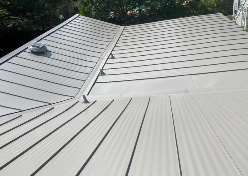 Solar attic fan installed on a metal roof for Roof Ventilation in Robbinsville